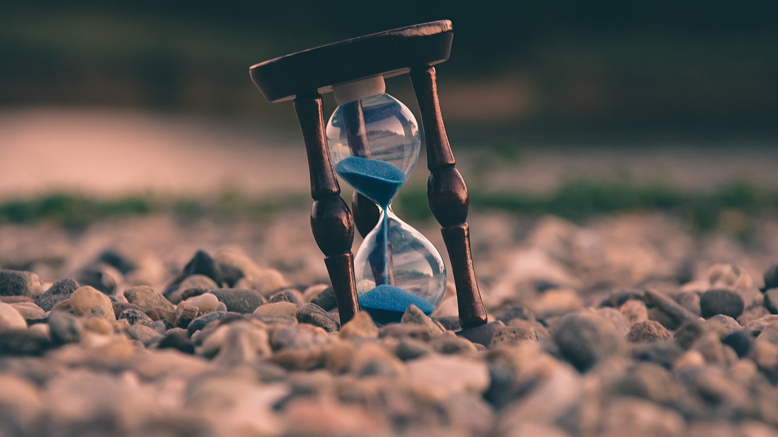 A simple wall clock showing the passage of time against a plain background.