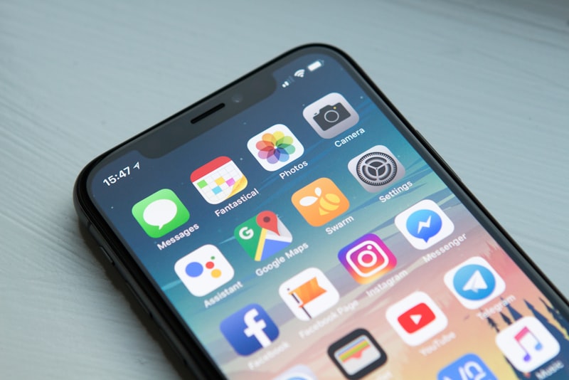 A person holding a smartphone with a learning app open on the screen.